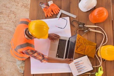 AdobeStock_345168086 Overhead construction with computer